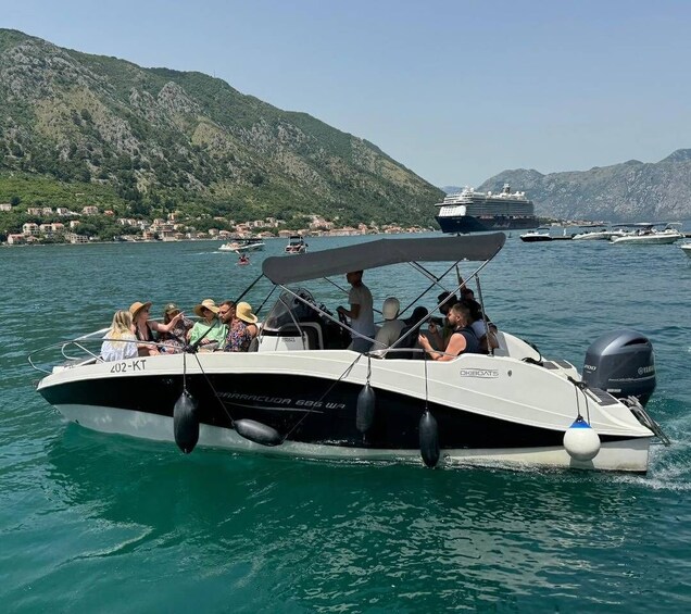 A boat with people on it, a large ship in the background, and a mountainous landscape. 5