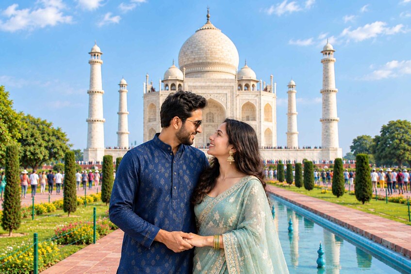 A couple standing in front of the Taj Mahal with a pool and greenery in the foreground. 1