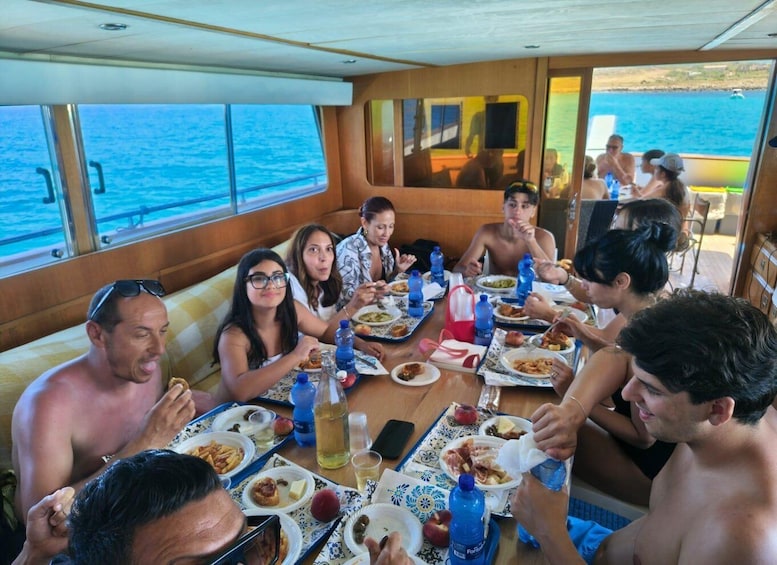 A group of people dining on a boat with a view of the sea. 5