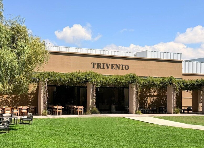 A building named TRIVENTO with outdoor seating and a well-maintained lawn. 4