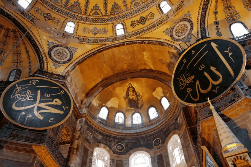 A domed interior with intricate Islamic calligraphy and geometric patterns. 5