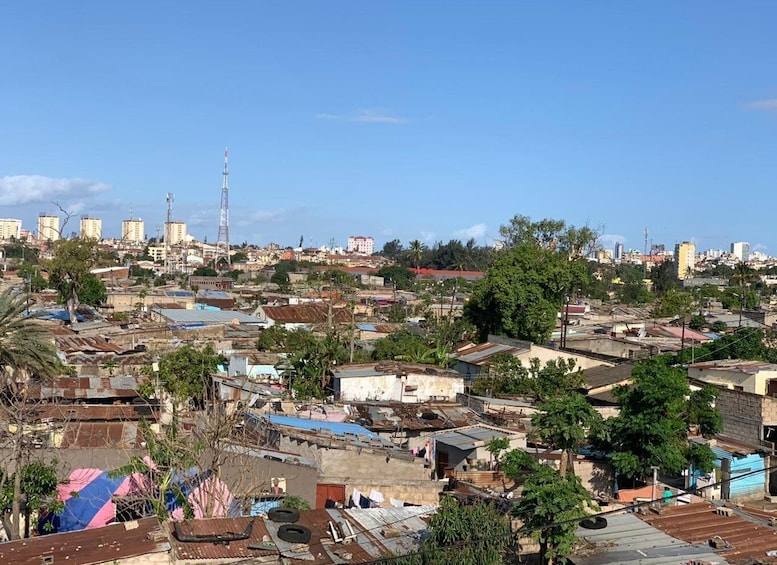 A densely populated urban area with a mix of residential and commercial buildings, including a prominent tower structure. 1