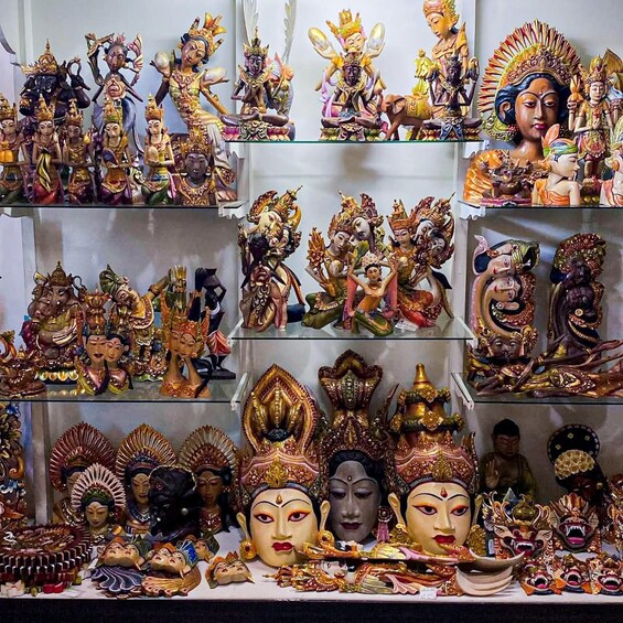 A collection of colorful statues and masks on display. 1