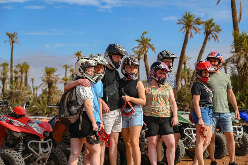 A group of people with ATVs in a tropical setting with palm trees. 5