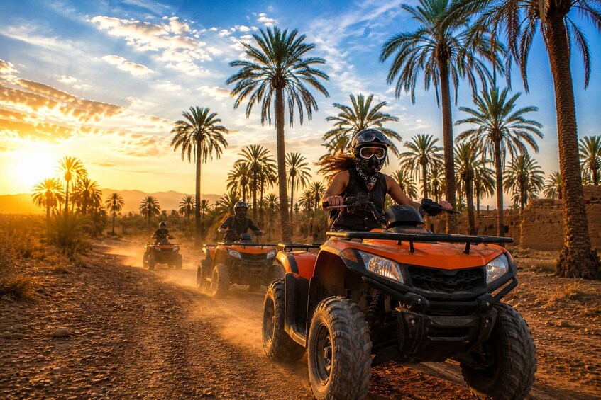 A person riding an ATV on a dirt road with palm trees in the background. 1