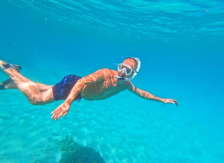 A person swimming underwater. 1