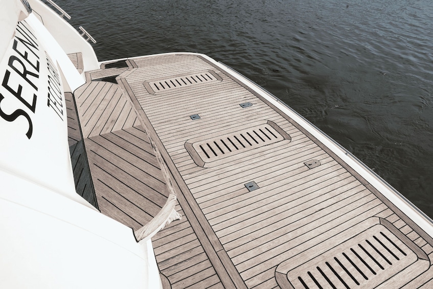 A boat's deck with a name 'SERENE' and a water body in the background. 2