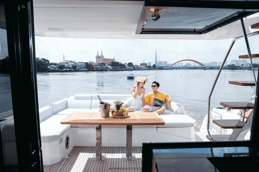 A couple on a boat with a city skyline in the background. 4