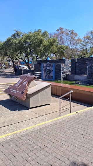 A playground with a slide and a bench. 1