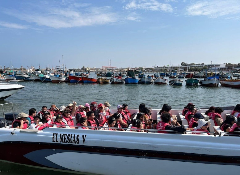 A boat named 'EL MESIAS V' with passengers wearing life jackets. 1