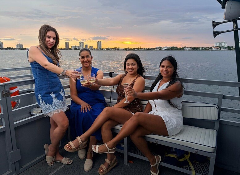 Four people toasting on a boat with a city skyline in the background. 5