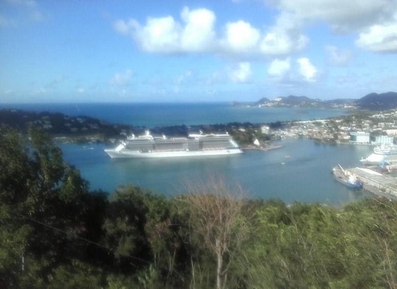 A cruise ship docked at a port with a cityscape in the background. 4