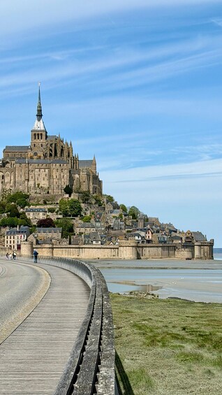 A historic castle on a hill overlooking a coastal town. 4