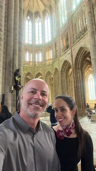 A cathedral interior with high vaulted ceilings and large stained glass windows. 3