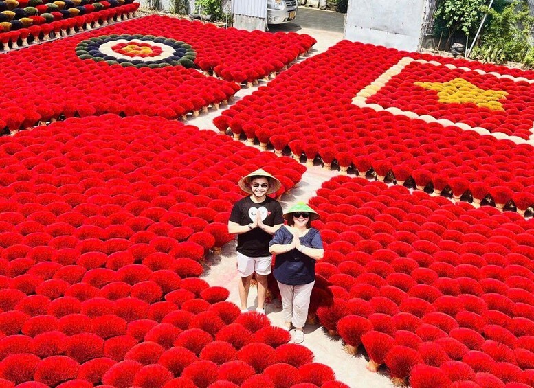 A large, meticulously arranged flower garden with red flowers, featuring geometric patterns and a central circular design. 4
