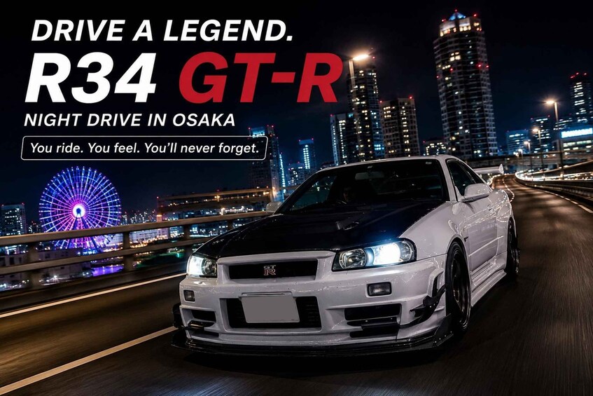 A white Nissan GT-R driving at night on a bridge with a city skyline in the background. 1