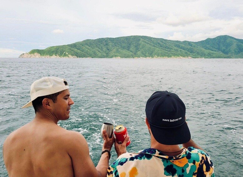 Two people on a boat, one holding a can and the other holding a glass. 5