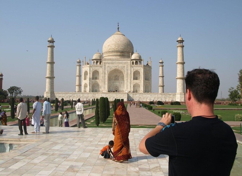 The Taj Mahal with visitors around it. 4
