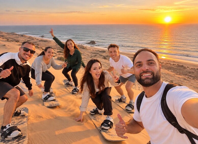 A group of people on a beach at sunset. 2