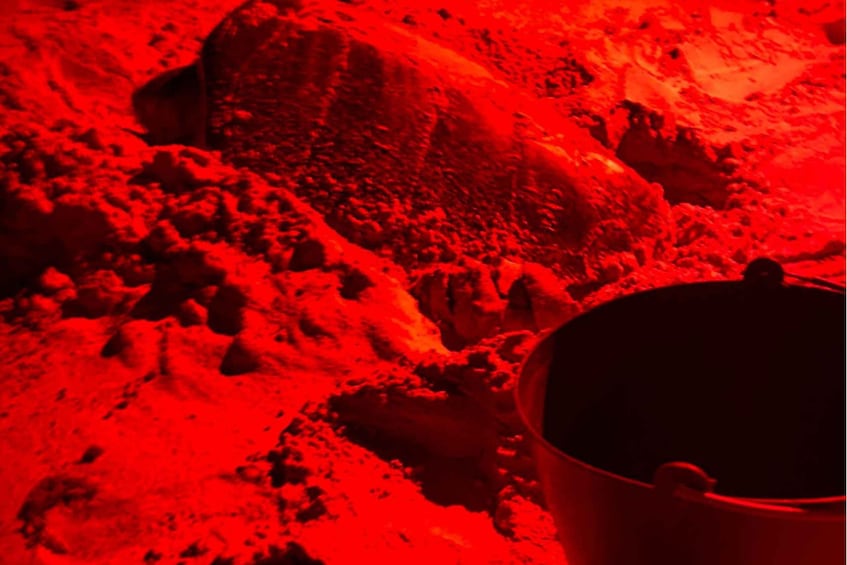 A red-lit rocky landscape with a metal bucket. 3
