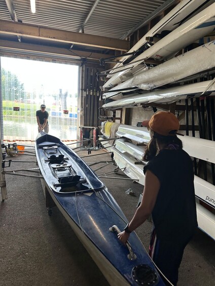 A boat repair shop with boats lined up and a person working on a boat. 5