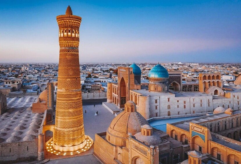 A historic cityscape with a prominent minaret and domed buildings. 4