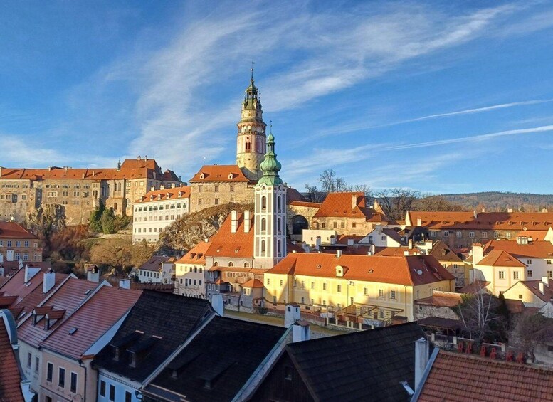 A historic town with a prominent church tower and surrounding buildings. 5