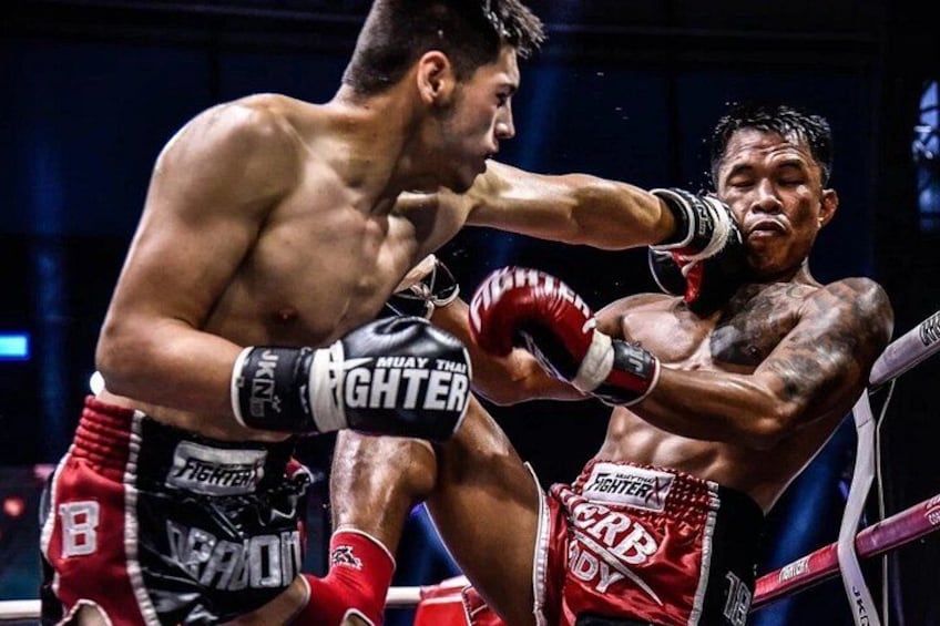 Two boxers in a ring, one delivering a punch to the other. 1