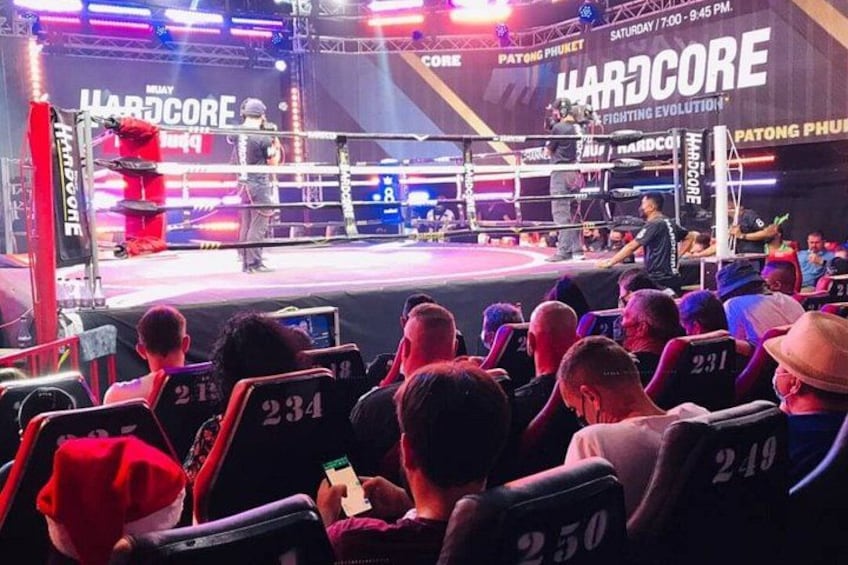 A boxing ring with a crowd seated in front. 4