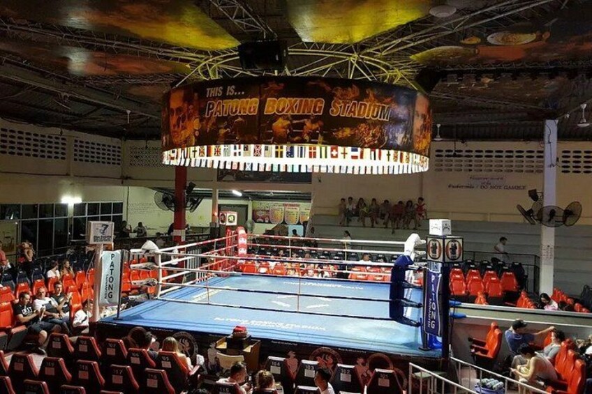 A boxing ring surrounded by spectators in a stadium. 5