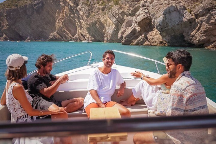 A group of people on a boat near rocky cliffs. 4