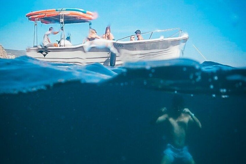 A boat with people on it, floating on water. 4