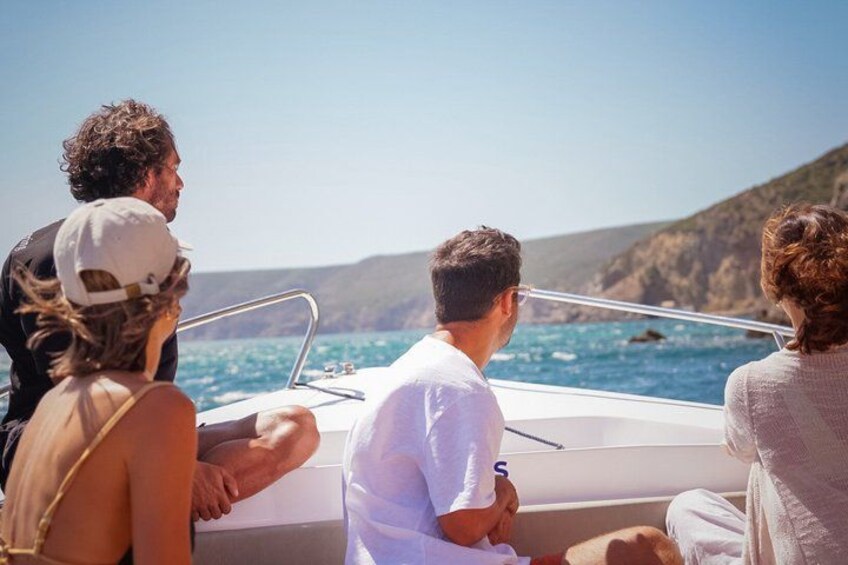 A group of people on a boat with a coastal landscape in the background. 5
