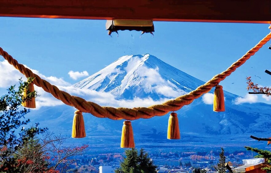 A rope with tassels in front of a snow-capped mountain. 1