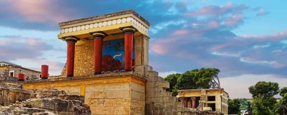 Ancient ruins with columns and a mural. 5