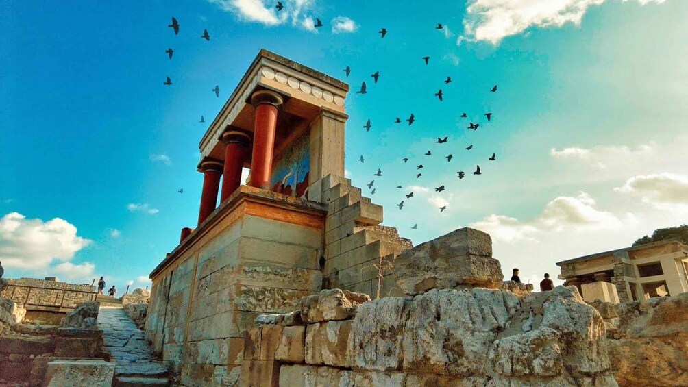 Ancient ruins with columns and a staircase. 1