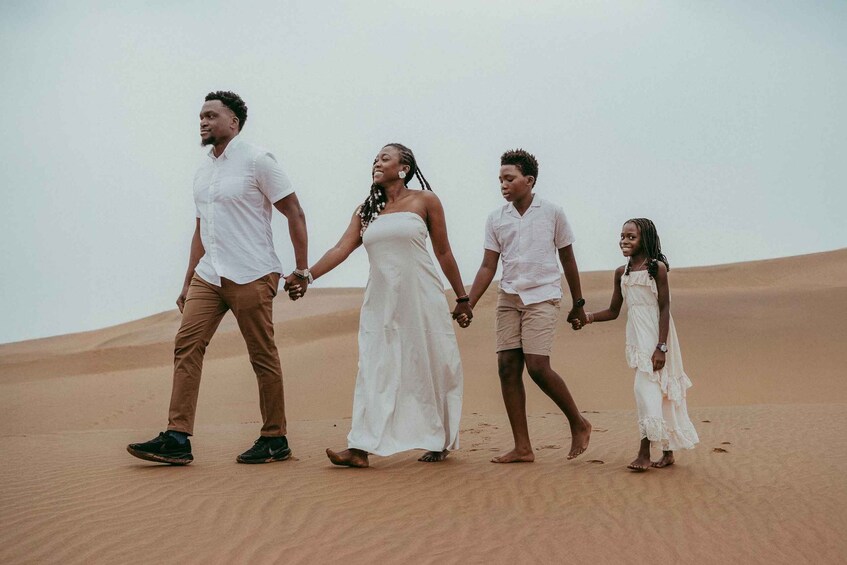 A family walking on a sandy beach. 2