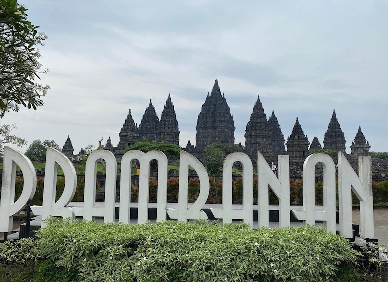 A large white sign with the word 'PRAMRANAN' in front of ancient temple structures. 5