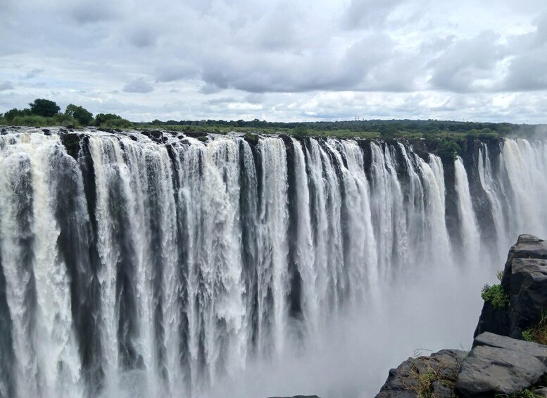A large waterfall cascading over a cliff. 1