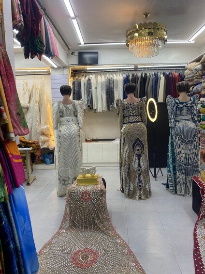 A clothing store with mannequins displaying dresses. 3