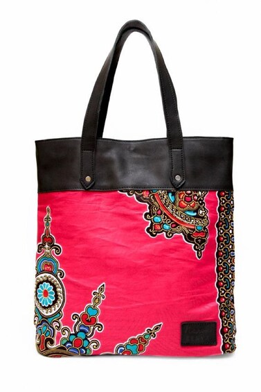 A red and black tote bag with intricate embroidery. 4