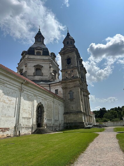 A historic church with a clock tower and a large arched entrance. 3
