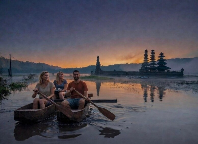 Three people in a wooden boat on a calm body of water with a traditional pagoda in the background. 1