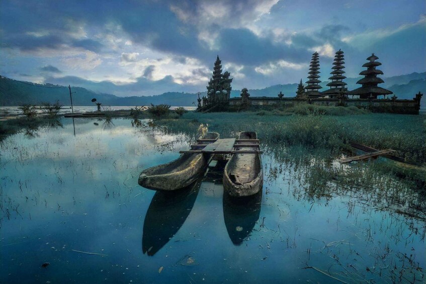 A serene lake with traditional pagoda-style structures in the background. 3