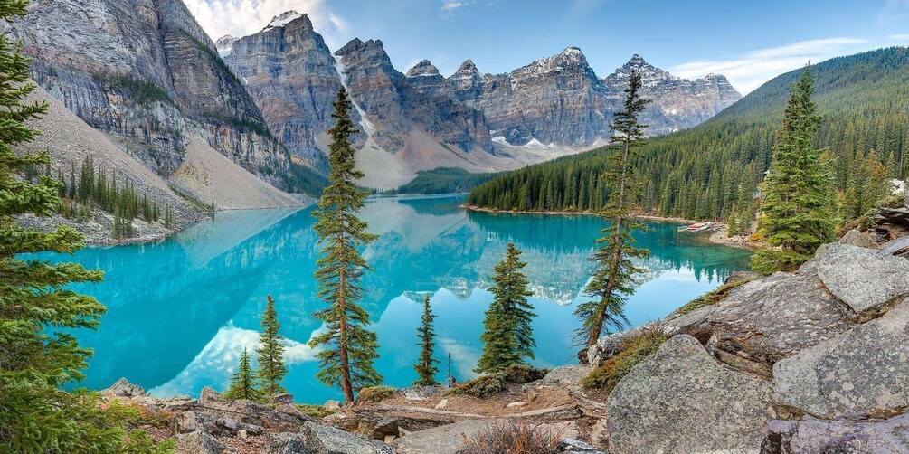 A mountain lake surrounded by rugged peaks and coniferous trees. 3