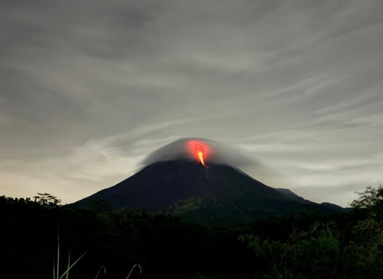 A volcano with a glowing red lava flow at the summit. 5