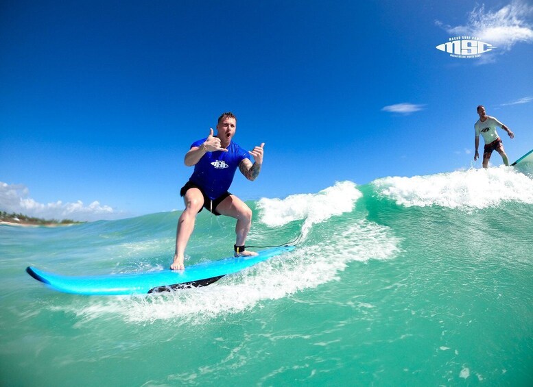 A person surfing on a wave with a clear blue sky in the background. 3