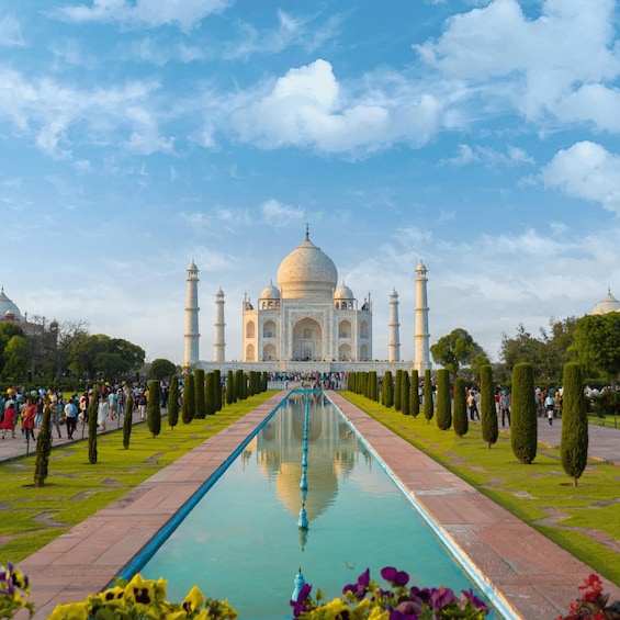 The Taj Mahal with a reflecting pool and visitors. 4