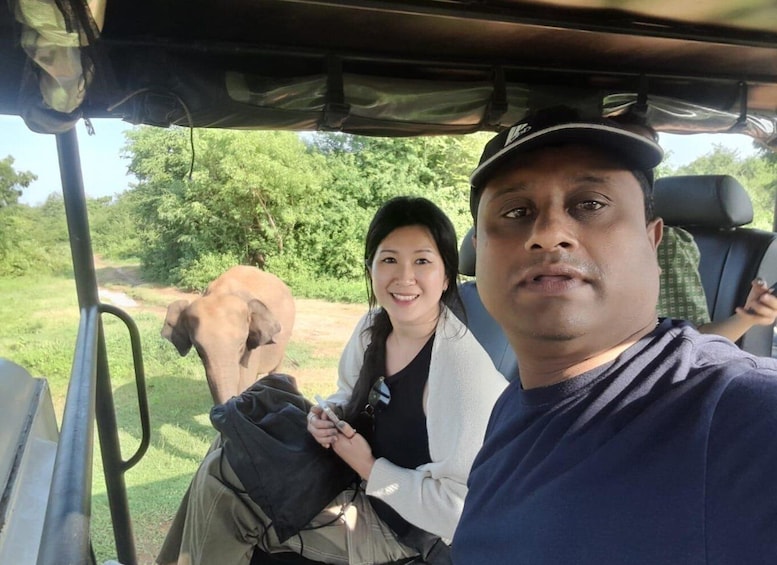 A vehicle with a person holding a camera and another person in the background. 5