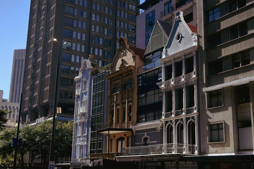 A historic building with ornate architecture, including a clock tower and decorative elements. 3